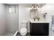 Modern bathroom featuring a sleek vanity, a chic mirror and walk in shower with gray tiling at 1730 N Gaylord St, Denver, CO 80206
