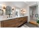 Dual-sink bathroom features wooden cabinetry, sleek fixtures, and a modern aesthetic at 1730 N Gaylord St, Denver, CO 80206