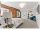 Charming bedroom with exposed brick wall, carpet floors, and lots of natural light at 1730 N Gaylord St, Denver, CO 80206