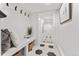 Bright entryway with hexagon tile floors, bench seating, and coat hooks at 1730 N Gaylord St, Denver, CO 80206