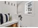 Cozy entryway nook with bench seating, white wainscoting, and a charming window at 1730 N Gaylord St, Denver, CO 80206