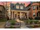 Charming brick home with a covered front porch, columns, and landscaped front yard at 1730 N Gaylord St, Denver, CO 80206