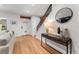 Bright foyer features hardwood floors, staircase with wrought iron railing, and stylish console table at 1730 N Gaylord St, Denver, CO 80206
