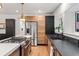 Modern kitchen features stainless steel appliances, hardwood floors, and stone counters at 1730 N Gaylord St, Denver, CO 80206