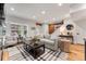 Bright living room features hardwood floors, exposed brick, and stylish furnishings at 1730 N Gaylord St, Denver, CO 80206