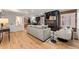 Open-concept living room with hardwood floors, fireplace, and seamlessly connected kitchen in background at 1730 N Gaylord St, Denver, CO 80206