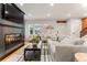 Bright living room with fireplace, large TV, stylish furniture, and hardwood floors at 1730 N Gaylord St, Denver, CO 80206