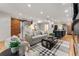 Bright living room features hardwood floors, exposed brick, and open kitchen at 1730 N Gaylord St, Denver, CO 80206