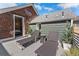 Relaxing rooftop patio with modern lounge chairs, privacy trees, and views of the home's exterior at 1730 N Gaylord St, Denver, CO 80206