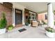 Inviting covered porch with seating area and lovely garden, perfect for relaxing and socializing at 1730 N Gaylord St, Denver, CO 80206