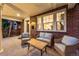 Inviting covered porch with seating area, perfect for relaxing and enjoying the neighborhood views at 1730 N Gaylord St, Denver, CO 80206