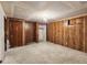 Large, unfinished bedroom with paneled walls and ample space for customization and renovation at 4291 W Wagon Trail Dr, Littleton, CO 80123