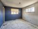 Bedroom featuring two windows and damaged walls and floors at 4291 W Wagon Trail Dr, Littleton, CO 80123