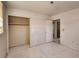 Bedroom featuring a closet, entryway, and damaged walls and floors at 4291 W Wagon Trail Dr, Littleton, CO 80123