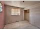 Bedroom featuring a closet, pink walls, and a window at 4291 W Wagon Trail Dr, Littleton, CO 80123