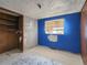Bedroom featuring an empty closet, blue walls, and a window at 4291 W Wagon Trail Dr, Littleton, CO 80123