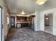 Open kitchen layout with stainless steel fridge, offering ample space and natural light at 4291 W Wagon Trail Dr, Littleton, CO 80123