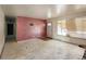 Living room featuring a front door and window, with worn flooring and walls at 4291 W Wagon Trail Dr, Littleton, CO 80123
