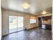 Living room featuring a sliding glass door, window, and stainless steel dishwasher at 4291 W Wagon Trail Dr, Littleton, CO 80123