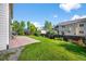 Large, lush backyard featuring a patio and beautiful landscaping, ideal for outdoor activities and relaxation at 650 Olympia Ave, Longmont, CO 80504