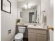 Charming half bathroom with neutral decor, pedestal sink, and a framed mirror offers a functional space at 650 Olympia Ave, Longmont, CO 80504