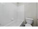 Tiled bathroom features a bathtub, toilet, and clean modern fixtures at 650 Olympia Ave, Longmont, CO 80504
