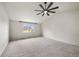 Large bedroom with plush carpeting and a large window. The modern fan is a nice feature at 650 Olympia Ave, Longmont, CO 80504