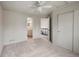 Bedroom featuring a ceiling fan, closet, and access to an ensuite bathroom at 650 Olympia Ave, Longmont, CO 80504