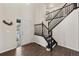 Grand entryway with hardwood floors and a staircase with dark wood railings at 650 Olympia Ave, Longmont, CO 80504