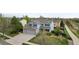 A home exterior with a well-manicured lawn, large driveway, and three-car garage at 650 Olympia Ave, Longmont, CO 80504