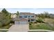 Aerial front view of home with a well-manicured lawn, driveway, and three-car garage at 650 Olympia Ave, Longmont, CO 80504