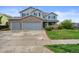 Charming two-story home with a three-car garage, red brick facade, and manicured lawn in a desirable neighborhood at 650 Olympia Ave, Longmont, CO 80504