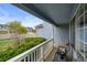 Inviting covered front porch with railing, seating area, and view of the neighborhood street at 650 Olympia Ave, Longmont, CO 80504
