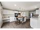 Bright, modern kitchen features white cabinets, stainless steel appliances, and a butcher block island with barstool seating at 650 Olympia Ave, Longmont, CO 80504