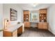 A well-lit home office provides ample workspace with built-in cabinets and a view of the outdoors at 650 Olympia Ave, Longmont, CO 80504
