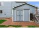 A large outdoor shed with painted double doors, side access to yard at 650 Olympia Ave, Longmont, CO 80504