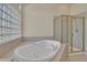 Luxurious bathroom featuring a soaking tub and glass-enclosed shower, providing a spa-like retreat at 11017 Meade Ct, Westminster, CO 80031