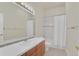Bathroom with white tiled countertop, updated fixtures and shower with bathtub at 11017 Meade Ct, Westminster, CO 80031