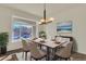 Dining room featuring a large window, modern chandelier, dining table, and contemporary decor at 11017 Meade Ct, Westminster, CO 80031