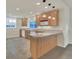 Charming kitchenette with counter seating, wood cabinets, and modern appliances at 11017 Meade Ct, Westminster, CO 80031