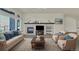 Cozy living room featuring a fireplace, built-in shelves, and comfortable seating at 11017 Meade Ct, Westminster, CO 80031