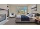 Serene main bedroom with fireplace, large windows, and a cozy sitting area for relaxation at 11017 Meade Ct, Westminster, CO 80031