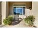Cozy patio with chairs, table, potted flowers, large window and exterior sconce at 11017 Meade Ct, Westminster, CO 80031