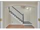Classic stairway with hardwood floors, white railings, and carpeted steps at 11017 Meade Ct, Westminster, CO 80031