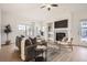 Bright living room featuring a fireplace, ceiling fan, and natural light at 15444 W 63Rd Ave # 101, Arvada, CO 80403