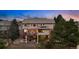 Spacious backyard boasting a deck with outdoor seating, a stone chess set, mature trees, and privacy at 7086 Esperanza Dr, Castle Pines, CO 80108