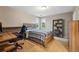 Comfortable bedroom with large windows, a wooden bed frame and a desk at 7086 Esperanza Dr, Castle Pines, CO 80108