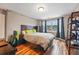 Cozy bedroom with hardwood floors, a large window, and custom curtains at 7086 Esperanza Dr, Castle Pines, CO 80108