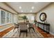 Elegant dining room featuring hardwood floors, stylish decor, and a large console table at 7086 Esperanza Dr, Castle Pines, CO 80108