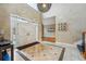 Grand entryway featuring tiled floors, a high ceiling with a decorative light fixture, and a double door entry at 7086 Esperanza Dr, Castle Pines, CO 80108